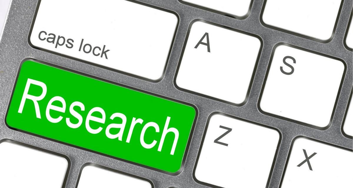 a keyboard with a key with the word "research"